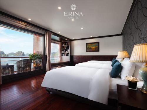 a bedroom with a large bed and a large window at Erina Cruise by HAG in Ha Long