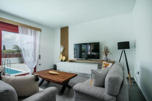 a living room with two couches and a table at SunDaLucky in Afantou