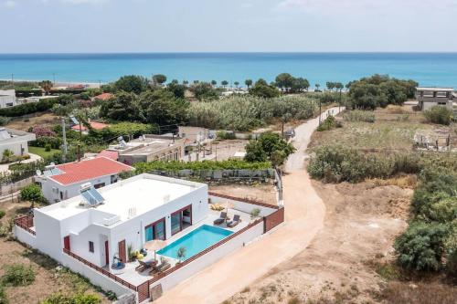 an aerial view of a house with a swimming pool at SunDaLucky in Afantou