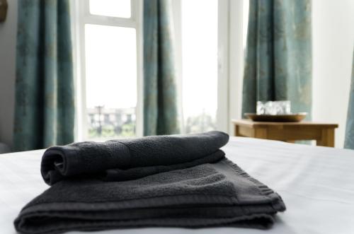 a pile of towels sitting on top of a bed at The Lakeside in Redcar