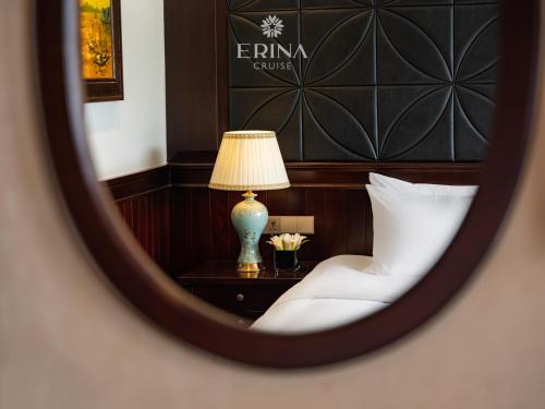 a bedroom with a bed and a table with a lamp at Erina Cruise by HAG in Ha Long