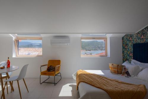 une chambre avec un lit, une table et des chaises dans l'établissement Hôtel & Résidence San Roccu, à Saint-Florent