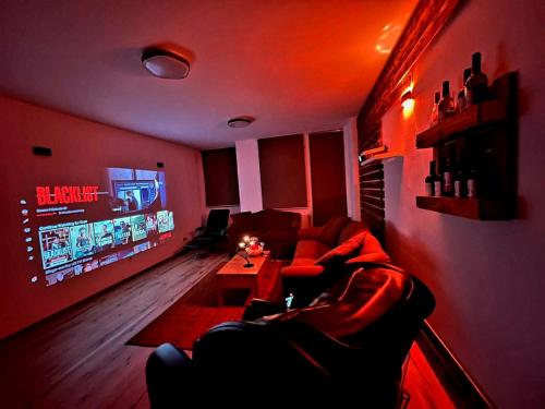 a living room with a couch and a flat screen tv at Cinema Relax Apartament in Prishtinë