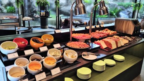 a buffet with many different types of food on display at Vibe Hotel Singapore Orchard in Singapore