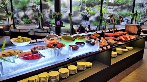 a buffet line with many different types of food at Vibe Hotel Singapore Orchard in Singapore