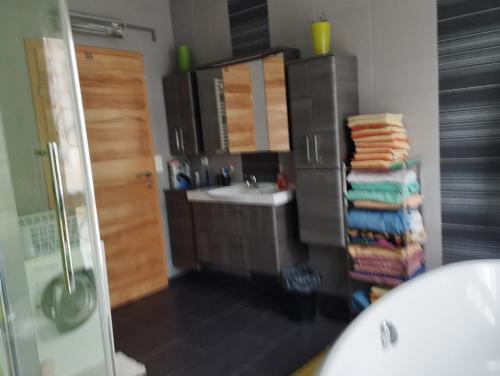 a bathroom with a sink and a stack of towels at Haus Maria in Neubach