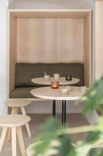 a living room with two tables and a couch at April1550 Boutique Hotel in Ljubljana