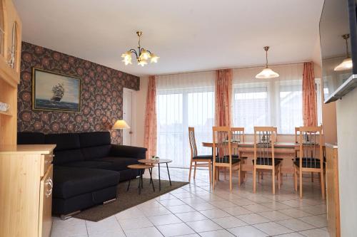 a living room with a couch and a table at Apartman Brigitte Bükfürdő in Bük