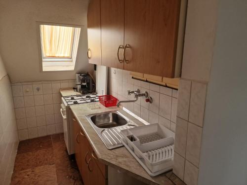 a small kitchen with a sink and a stove at reginavendeghaz in Balatonmáriafürdő