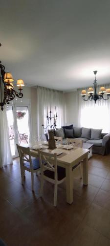 a living room with a table and a couch at Persefoni 's hause 1 in Nea Kalikratia