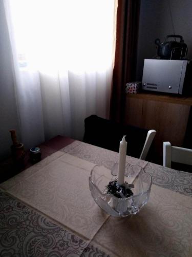 Апартамент Родопи في بايالا: شمعة في وعاء زجاجي على طاولة