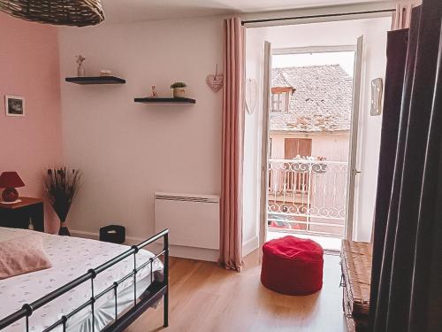 a bedroom with a bed and a large window at Mon Petit Coin de Paradis in Golinhac