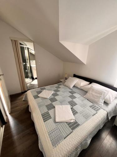 a bedroom with a large bed with towels on it at Apartment Antonia in Vrboska