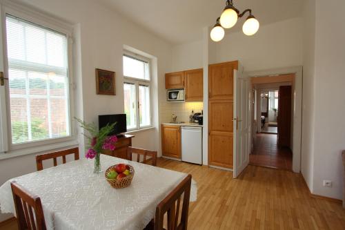 a kitchen with a table with a bowl of fruit on it at Penzion Jelen Vranov nad Dyjí in Vranov nad Dyjí