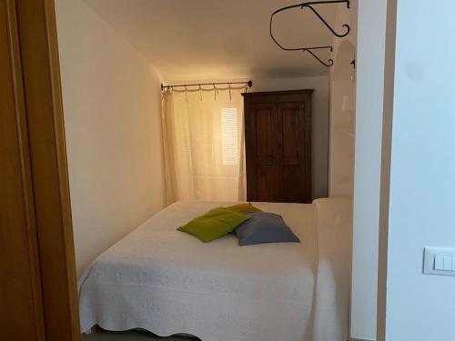a bedroom with a bed with two pillows on it at La Casetta in Lerici