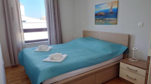 1 dormitorio con 1 cama con 2 toallas en Apartment Summerhill, en Primošten