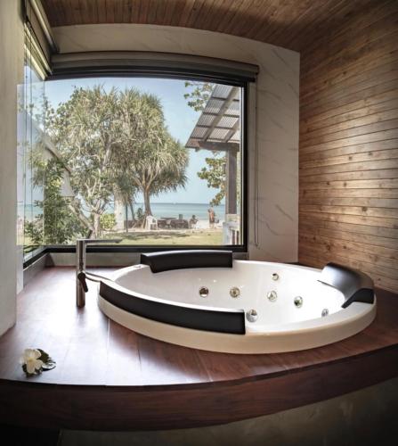 a bath tub in a room with a large window at Southern Lanta Resort in Ko Lanta
