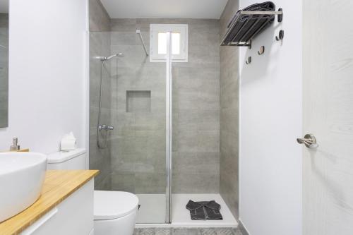 a bathroom with a shower with a toilet and a sink at Front beach studio in Callao Salvaje