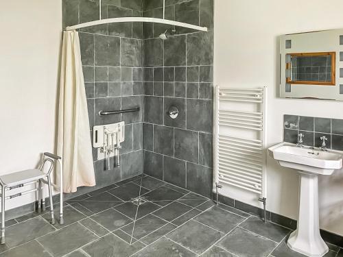 a bathroom with a shower and a sink at Manor Farm Retreat in Hainford