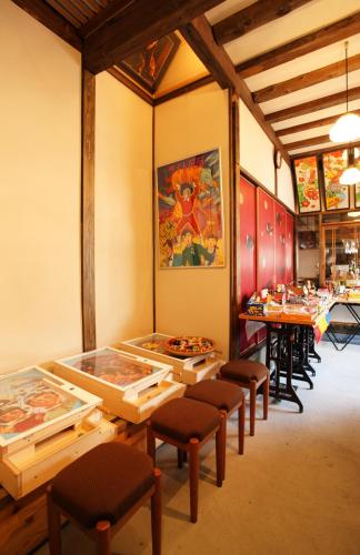 a dining room with tables and stools in a restaurant at 帝塚山忍者屋敷 in Osaka