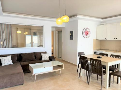 a living room with a couch and a table at Bella Mare Luxury Apartments in Kalamaki Heraklion
