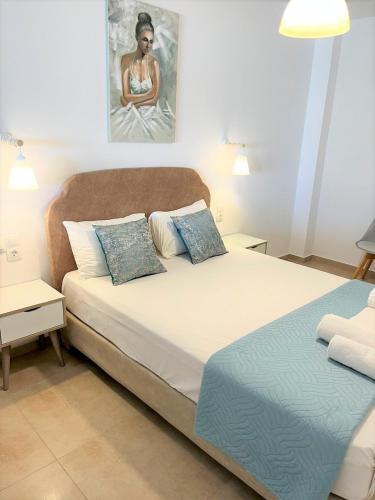 a bedroom with two beds and a painting on the wall at Bella Mare Luxury Apartments in Kalamaki Heraklion