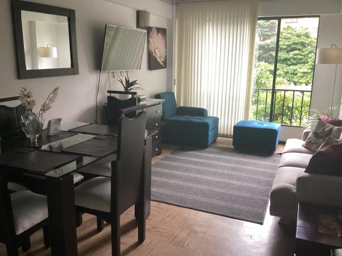 a living room with a dining table and a living room with a couch at Riberas apt, unique & memorable in Cali