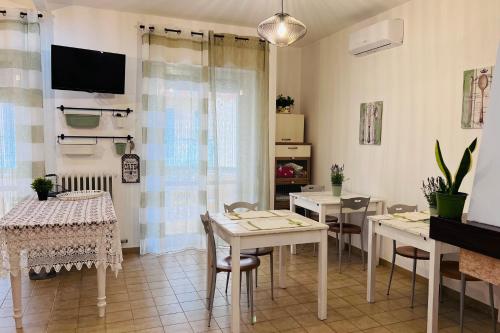 a living room with tables and chairs and a tv at B&B Stella Dei Venti in San Salvo