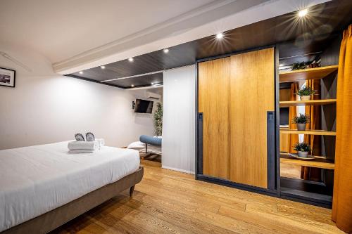 a bedroom with a bed and a sliding door at Martelli 6 Suite & Apartments in Florence