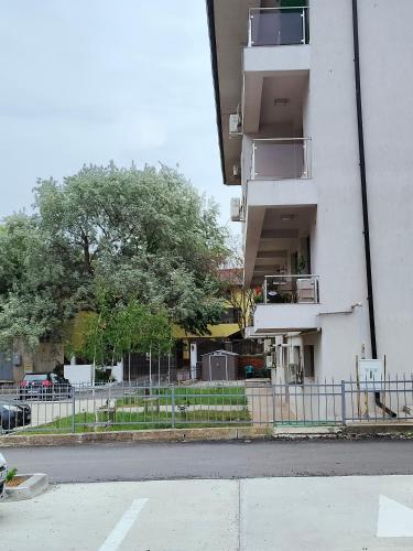 an apartment building with a fence next to a street at Studio Lorena in Mangalia