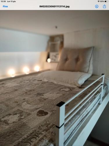 a bedroom with a bed with a white bed frame at Alloggio incantevole/ bedsitting-room in Altavilla Milicia