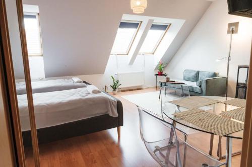a bedroom with a bed and a glass table at Sunny&Cozy Loft in Budapest