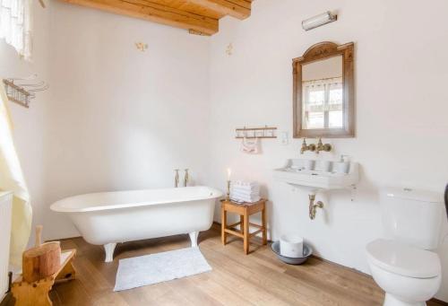a white bathroom with a tub and a sink at Vodní mlýn Wesselsky in Odry