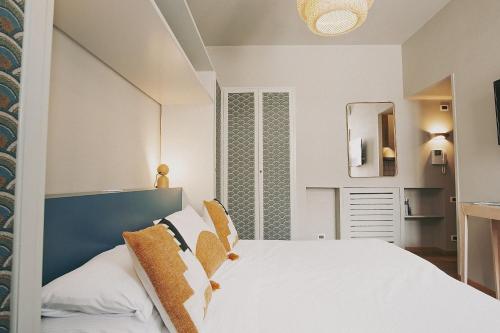 a bedroom with a white bed and a mirror at Salotto Monti in Rome