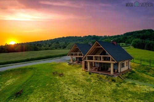 an overhead view of a house with the sunset in the background at Wood Szczęścia in Korczyna