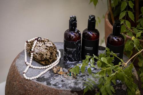 a table with three bottles of wine and a necklace at Villa Cambier by muse villas in Le Morne