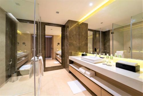 a bathroom with a large sink and a shower at Courtyard by Marriott Vadodara in Vadodara