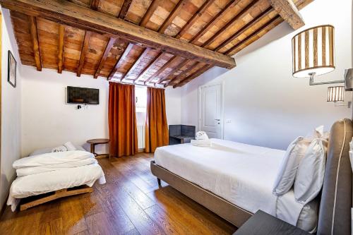 a bedroom with a large white bed and a table at Martelli 6 Suite & Apartments in Florence