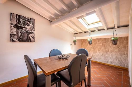 a dining room with a wooden table and chairs at Martelli 6 Suite & Apartments in Florence