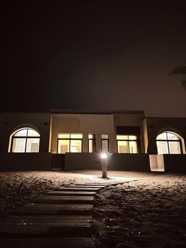 a building with a light in front of it at night at one bedroom villa in Salalah