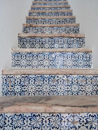a staircase with blue and white tiles on it at The Bastion Elvas Apartments in Elvas