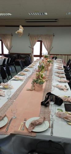a long table with plates and napkins on it at Villa Jana Guesthouse in Pretoria
