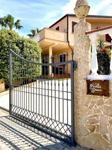 a metal gate in front of a house at Villa Grazia in Capo Vaticano