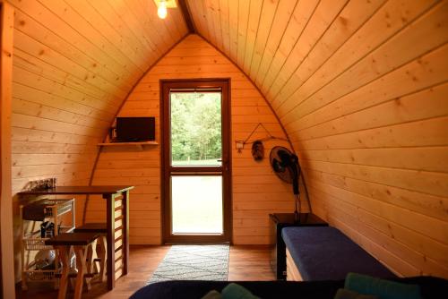 an attic room with a door in a cabin at Domek Wilcza Wola 2 in Górzanka