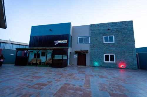 a large brick building with a red light in front of it at Bays Lodge, Accra in Accra