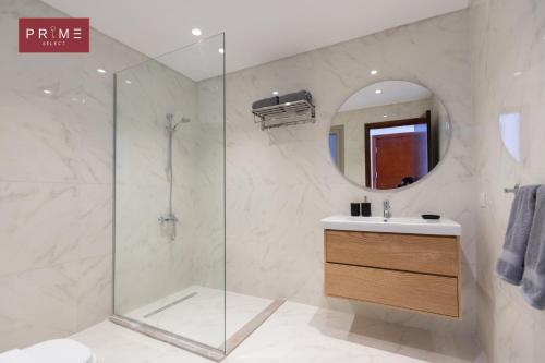 a bathroom with a shower and a sink and a mirror at Prime Select Galleria New Cairo in New cairo