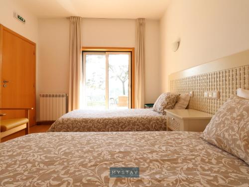 Ένα ή περισσότερα κρεβάτια σε δωμάτιο στο MyStay - Quinta Porto Ferrado