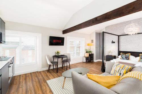 a kitchen and living room with a couch and a table at The Shirt Factory Apartments in Warrington