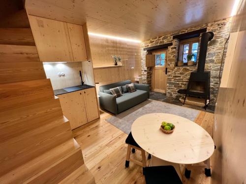 a living room with a table and a couch at Casas do Talasnal in Lousã