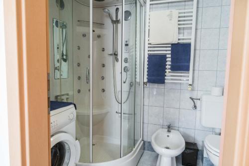 a bathroom with a shower and a toilet at Sunny&Cozy Loft in Budapest